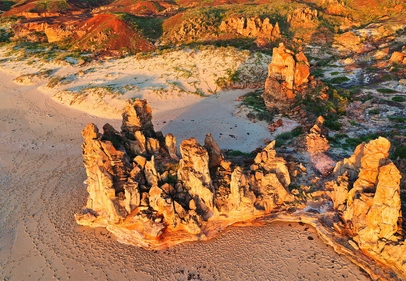 Aerial view of dramatic rock formations and white sandy beaches in Australia's North West