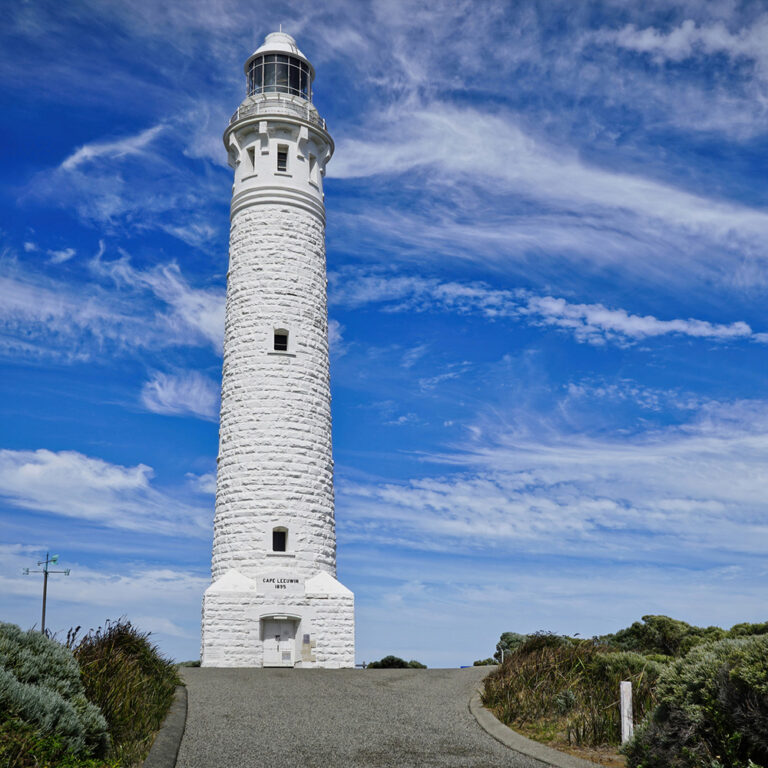 Historic Cape Leeuwin Lighthouse against a bright blue sky