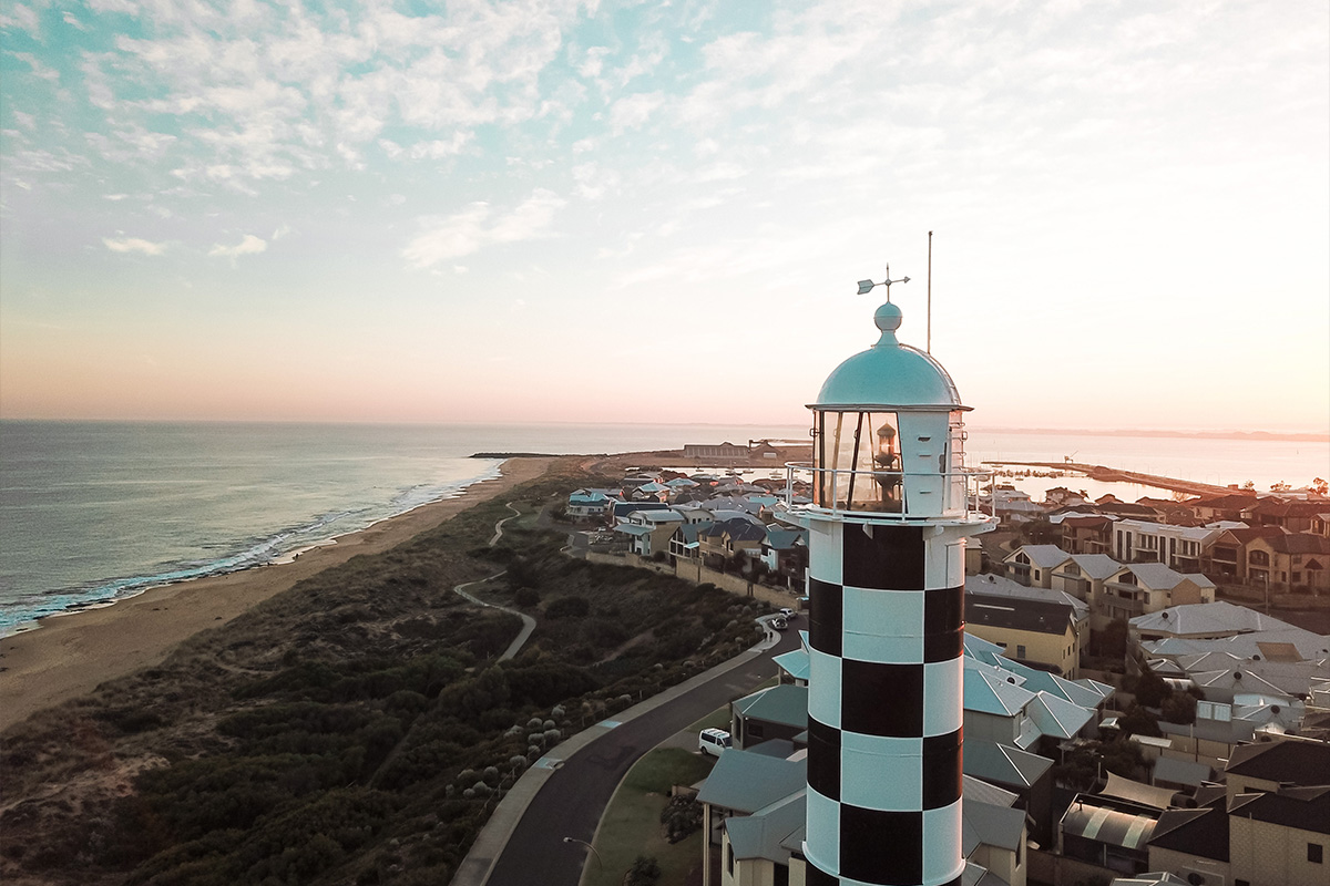 Lighthouse overlooking the coastline at sunset