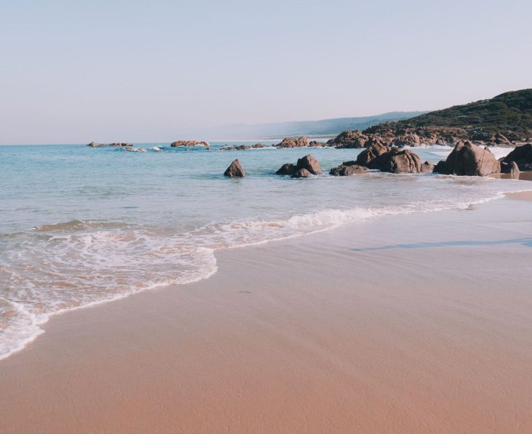 Beautiful beach with turquoise water and rocky outcroppings in Margaret River