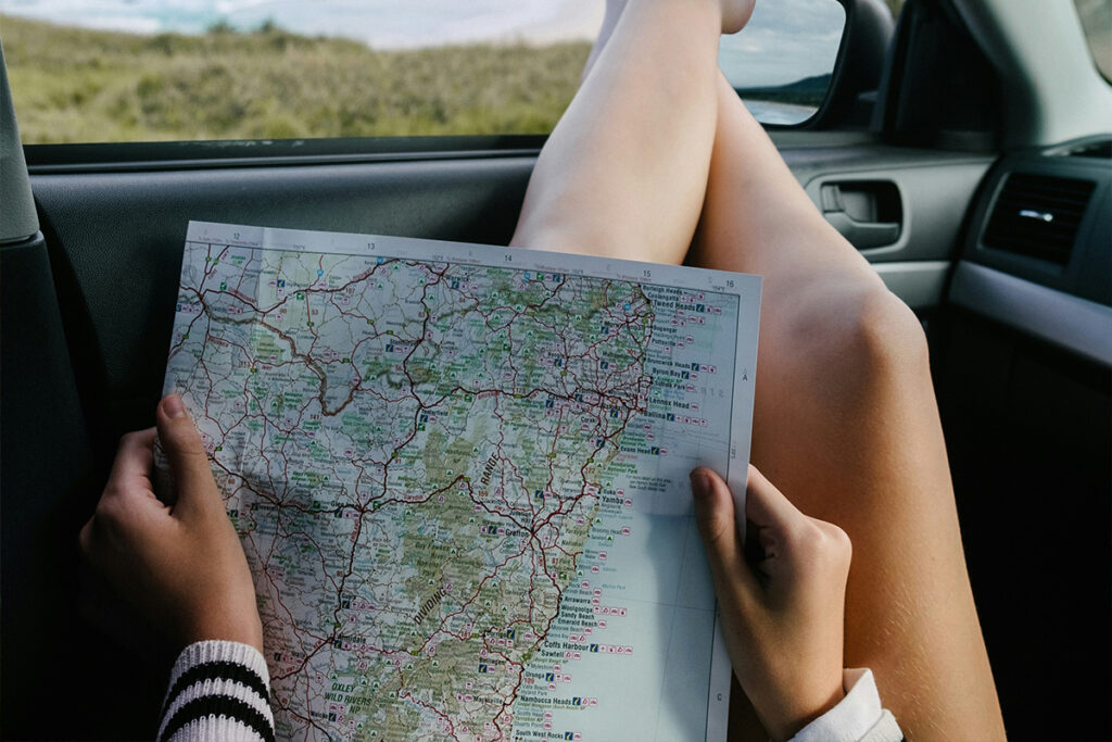How to get to Margaret River - Girl holding a map inside a car